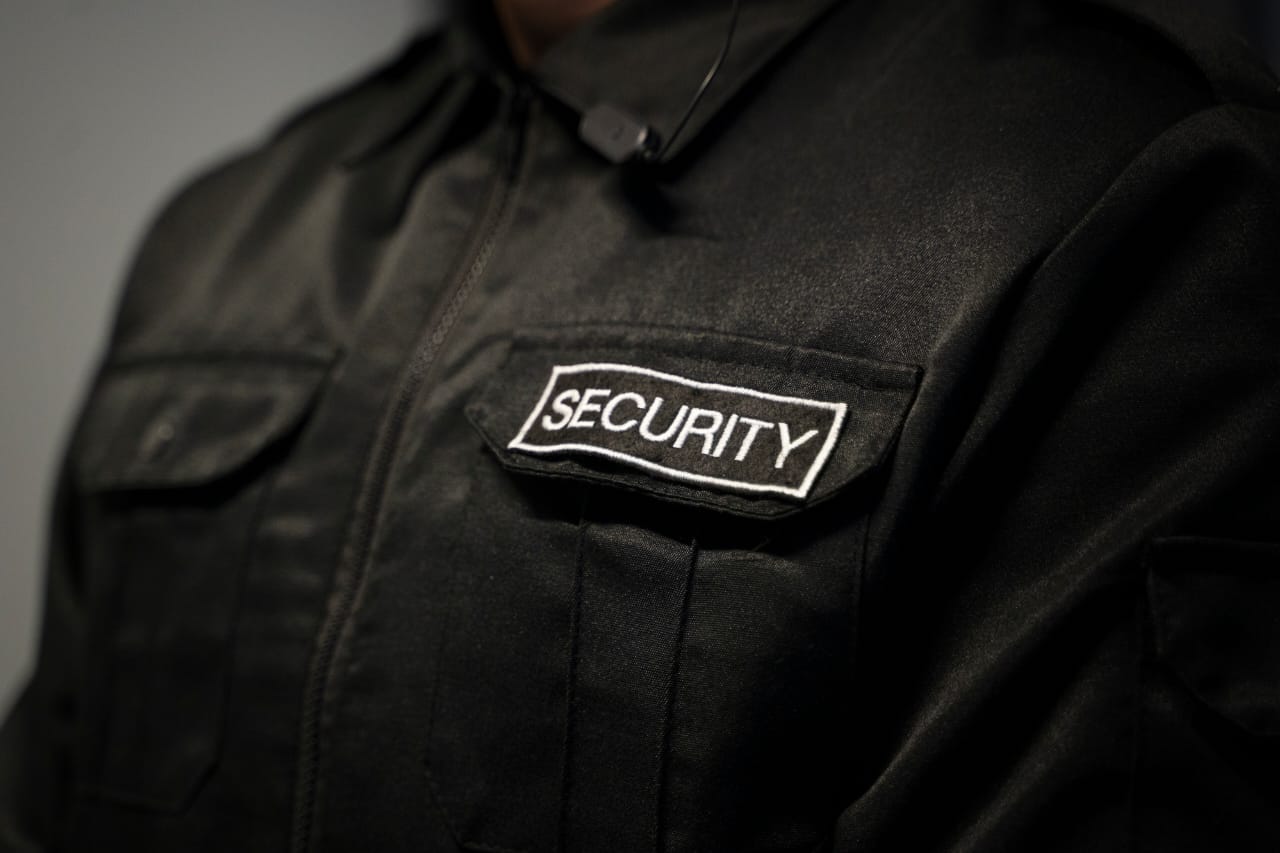 Security operative in black uniform with SECURITY badge